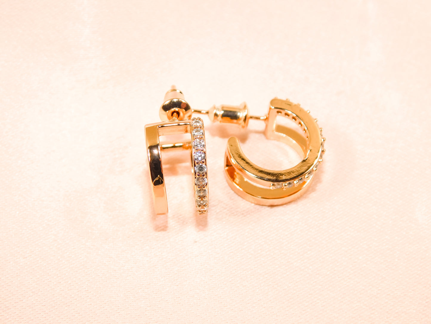 Close-up of rose gold barbell stud earrings