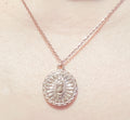 Dainty rose gold pendant necklace with a round charm