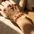 Hand wearing a rose gold bracelet 